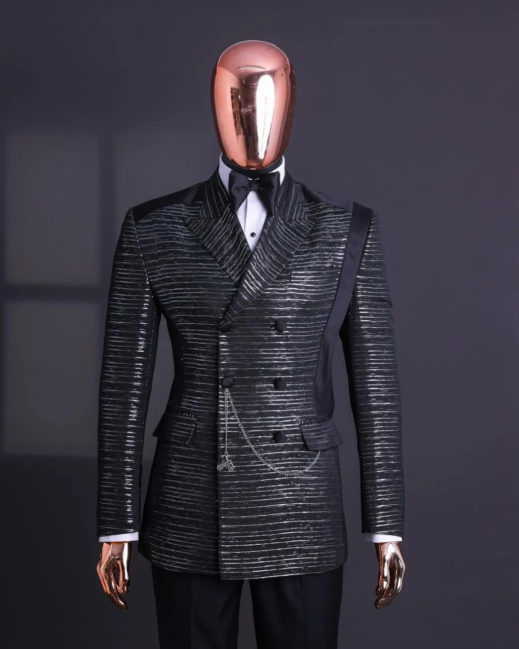 A Black and silver broom metallic scratch pattern jacquard, peak lapel tuxedo, tapered shoulder, double breasted suit