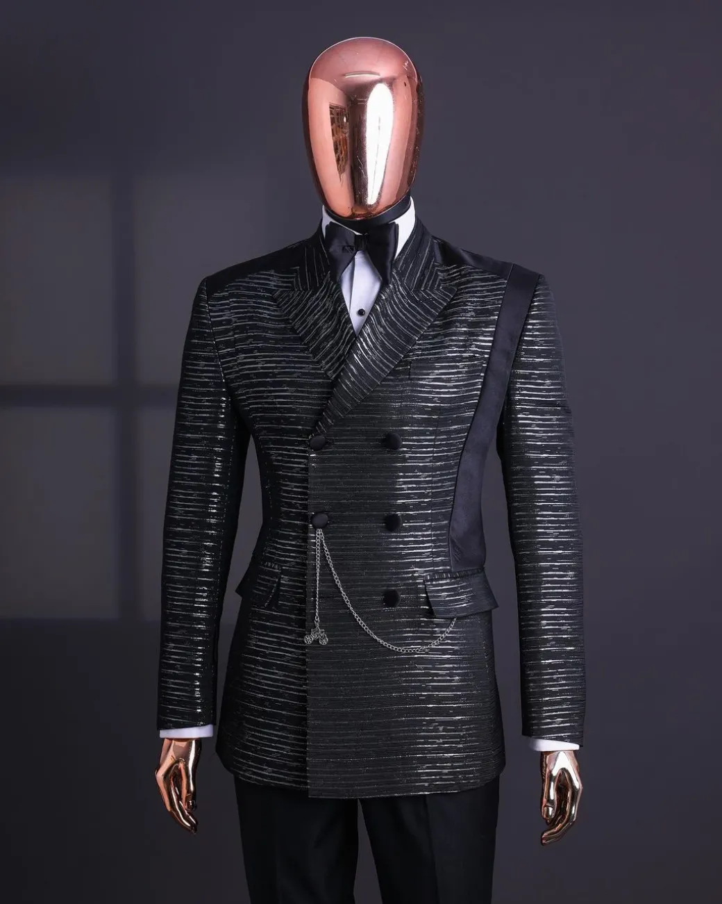 A Black and silver broom metallic scratch pattern jacquard, peak lapel tuxedo, tapered shoulder, double breasted suit