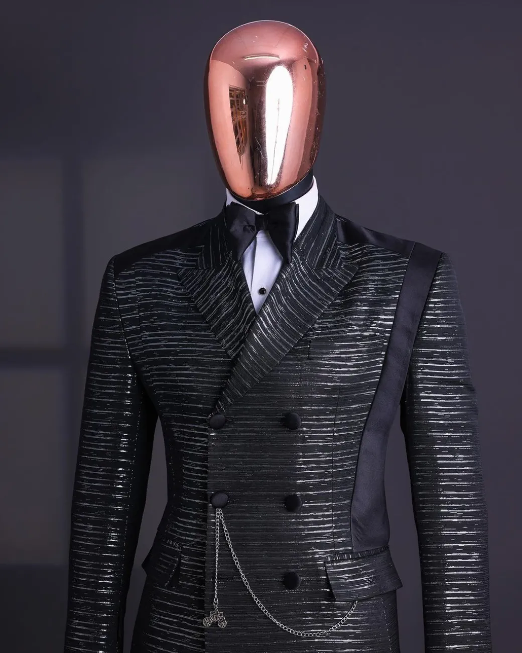 A Black and silver broom metallic scratch pattern jacquard, peak lapel tuxedo, tapered shoulder, double breasted suit