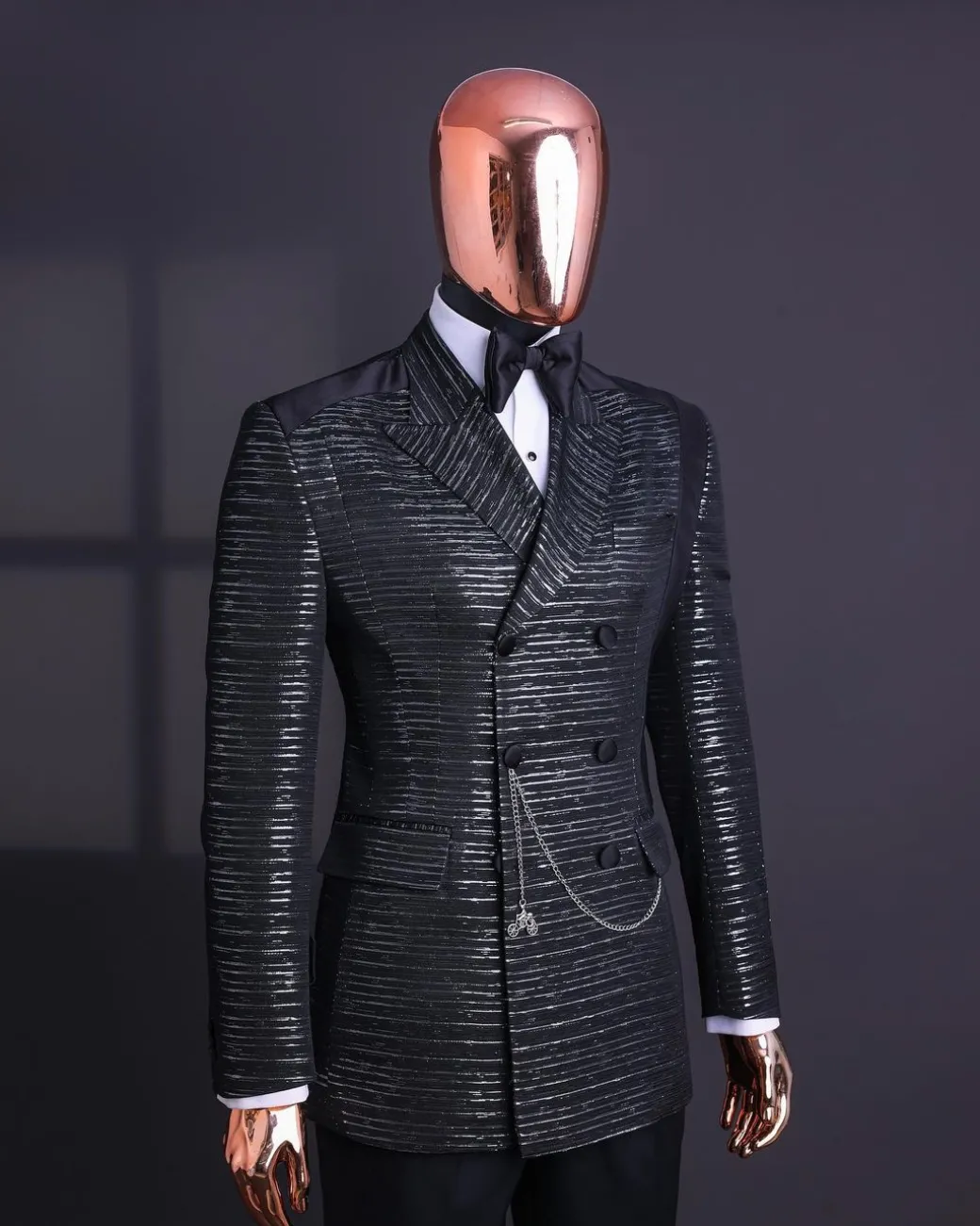 A Black and silver broom metallic scratch pattern jacquard, peak lapel tuxedo, tapered shoulder, double breasted suit