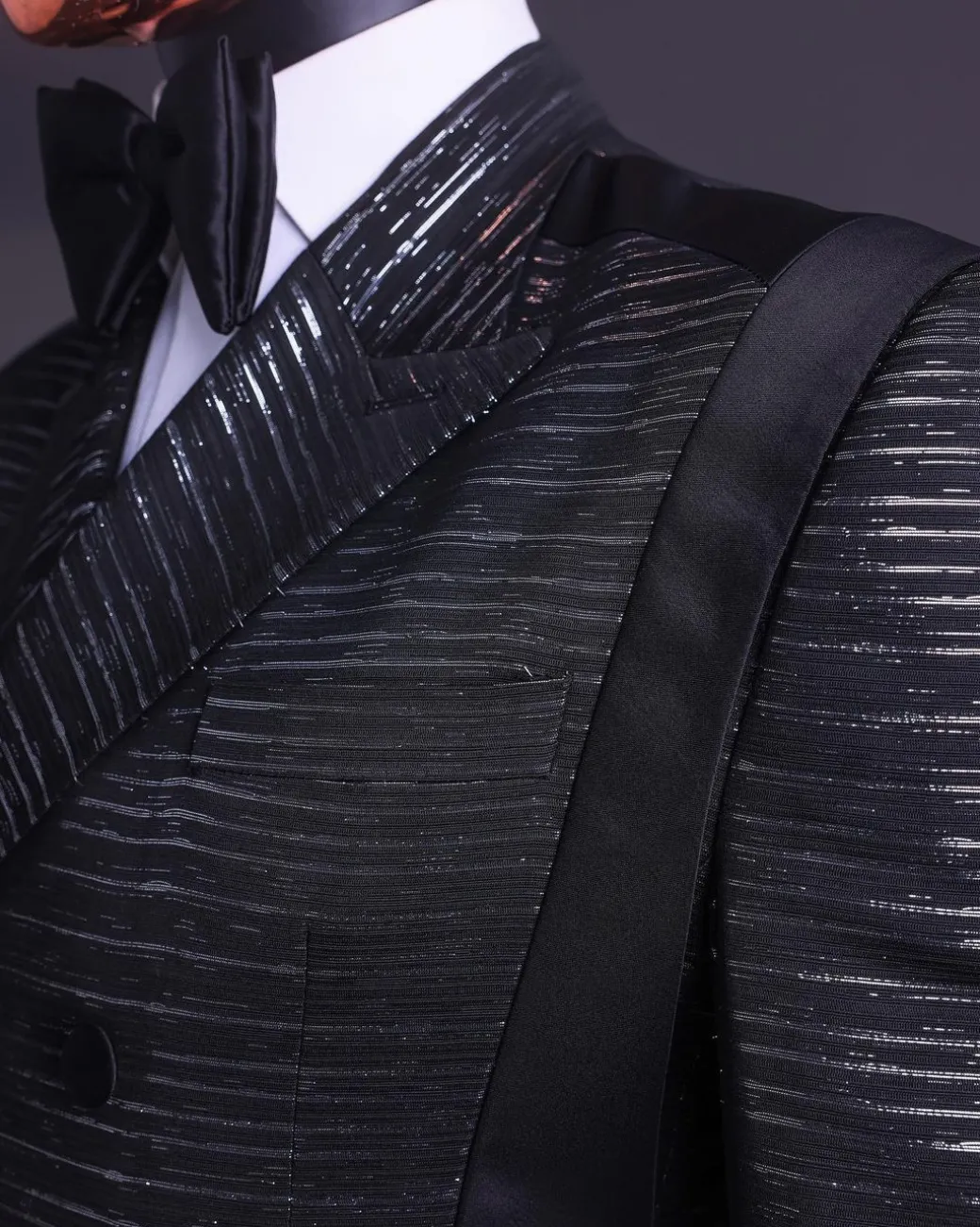 A Black and silver broom metallic scratch pattern jacquard, peak lapel tuxedo, tapered shoulder, double breasted suit