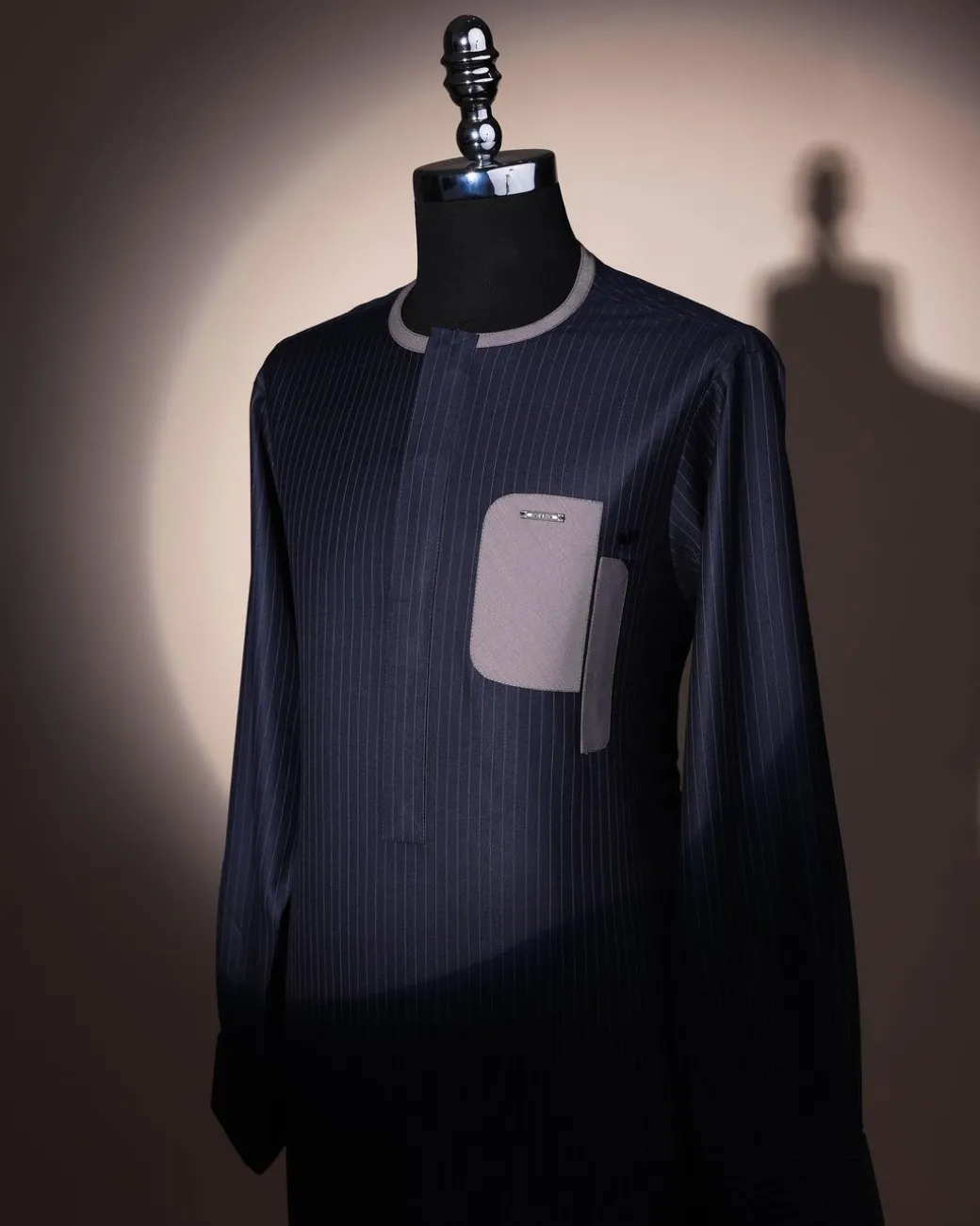 A black pencil stripe, dropping pocket, front flap, long sleeve African senator kaftan native.