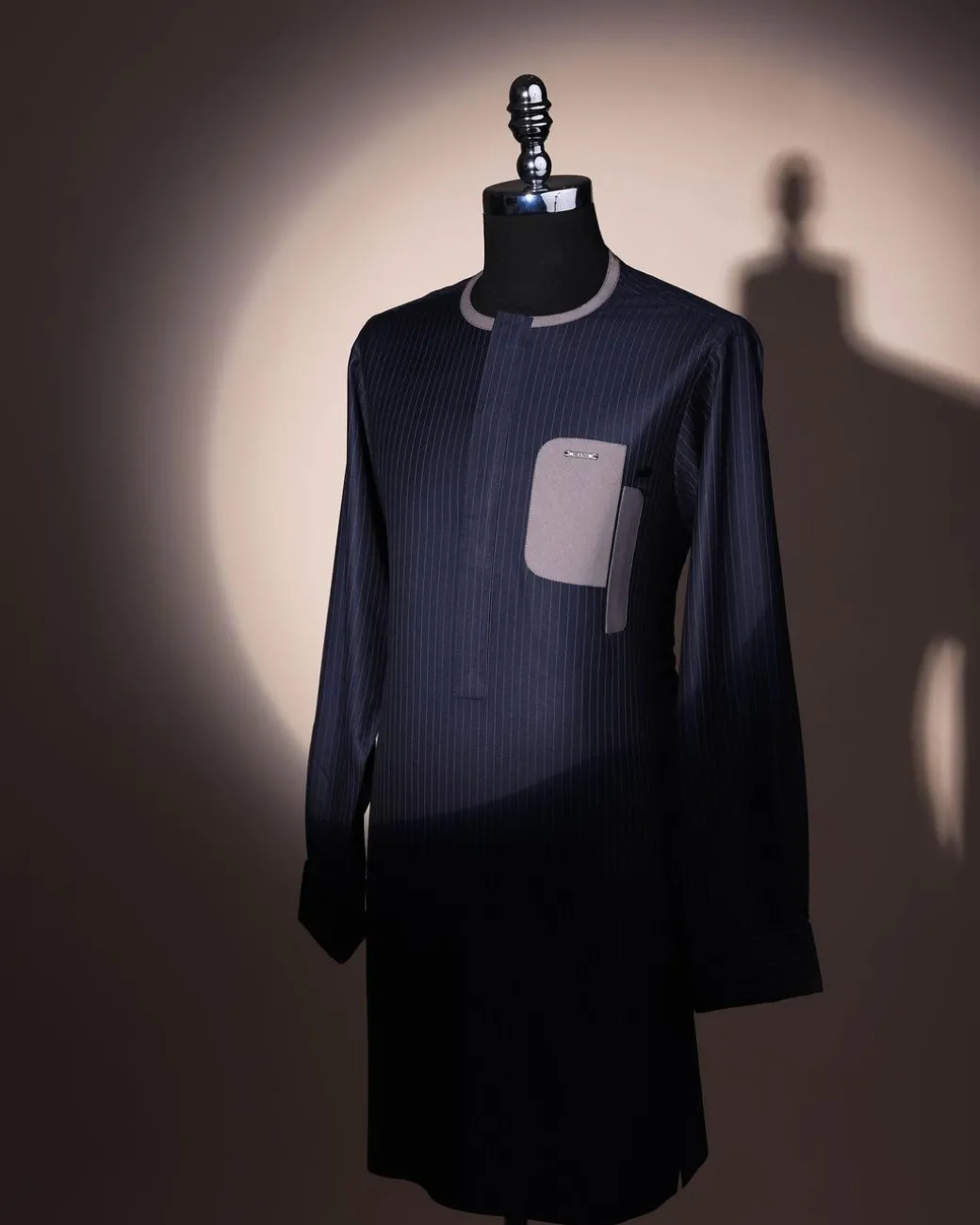 A black pencil stripe, dropping pocket, front flap, long sleeve African senator kaftan native.