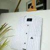 A black stripe and white African kaftan with black Swarovski buttons detailing and sokoto