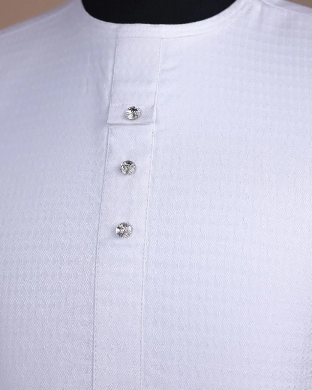 A bright white, front flap with Swarovski button, invisible zip line neck details, short sleeve African kaftan