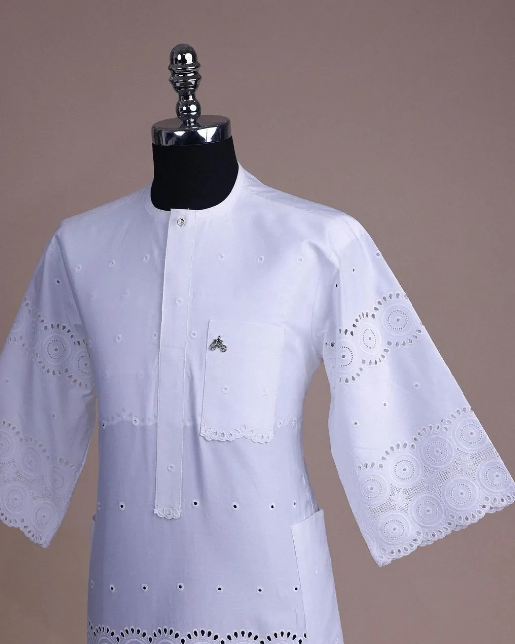 A bright white, Swiss patterned lace, front flap with Swarovski button, 3/4 sleeve African kaftan.