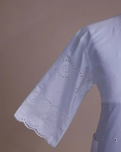 A bright white, Swiss patterned lace, front flap with left side pattern, Swarovski button, 3/4 sleeve African kaftan.