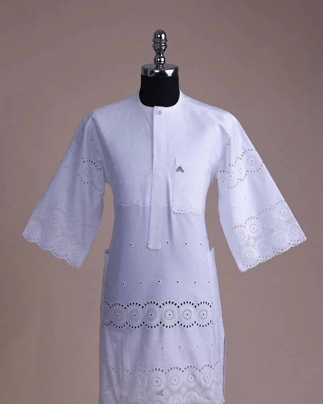 A bright white, Swiss patterned lace, front flap with Swarovski button, 3/4 sleeve African kaftan.