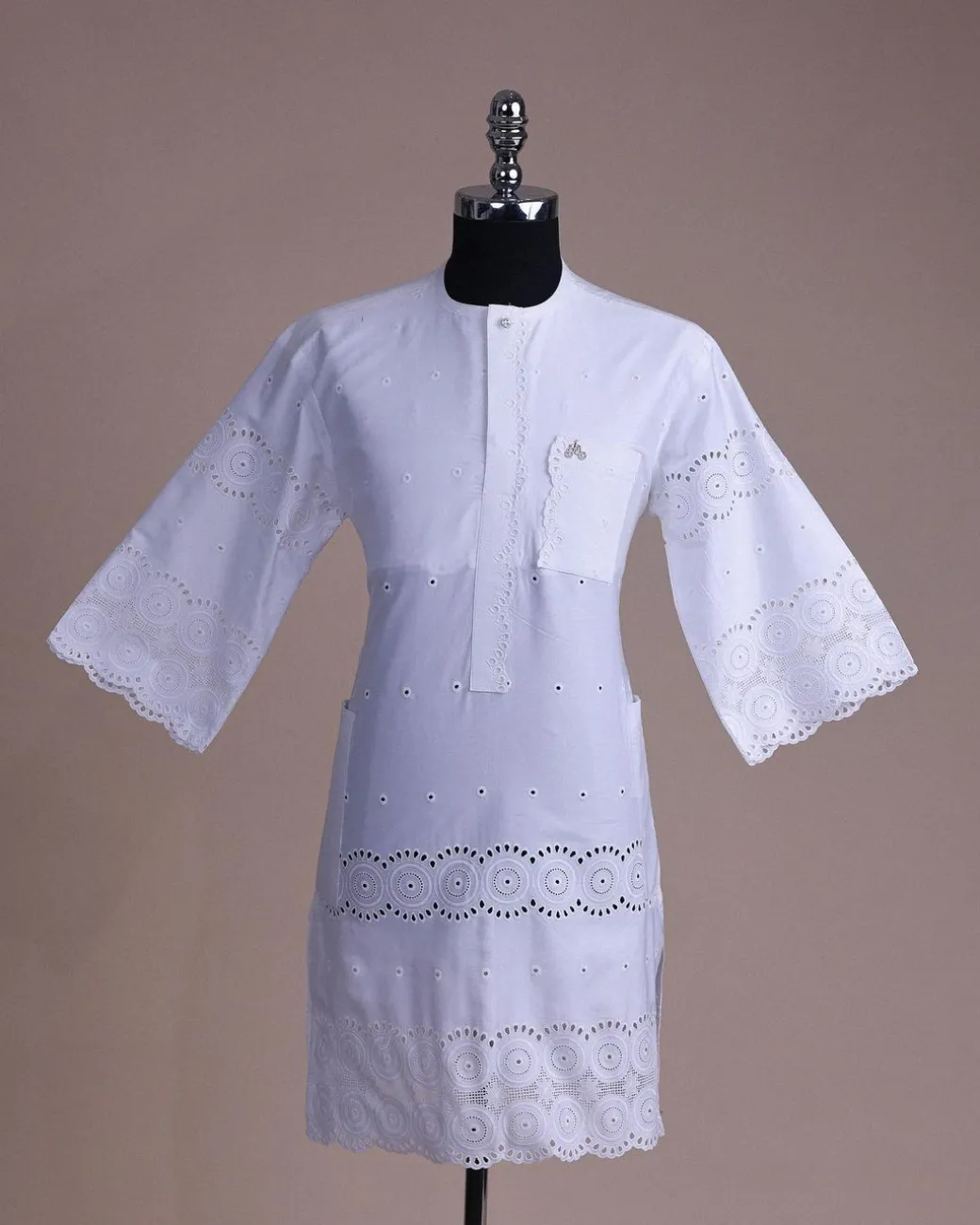 A bright white, Swiss patterned lace, front flap with left side pattern, Swarovski button, 3/4 sleeve African kaftan.
