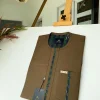 A brown African kaftan with a lining divisional design and Sokoto