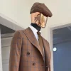 A brown and blue windowpane check papas hat.