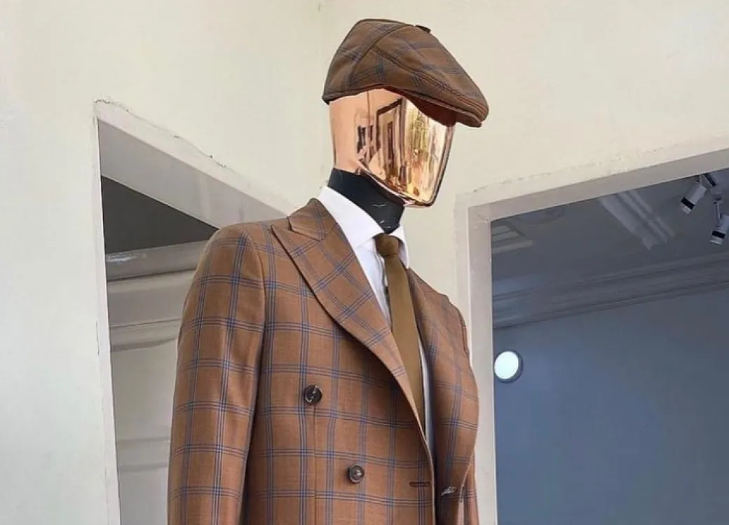 A brown and blue windowpane check papas hat.