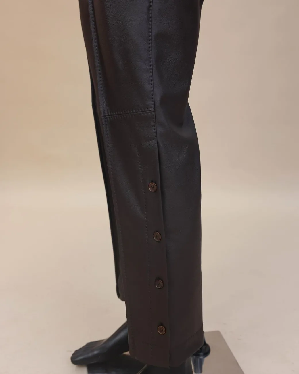 A brown leather, knitted & outer layered pant Trouser with side opening.
