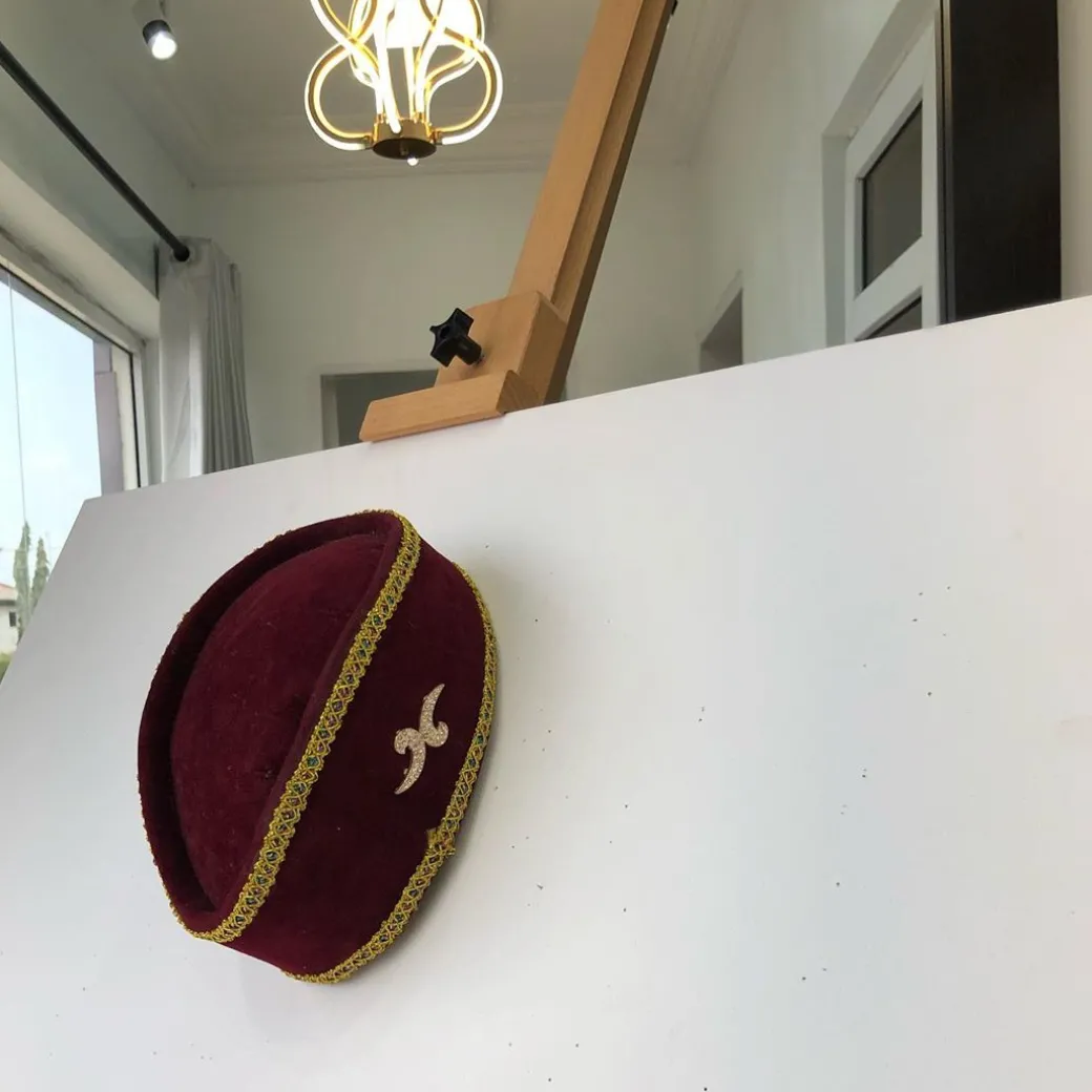 A Burgundy and Gold Ceremonial African Traditional Hat