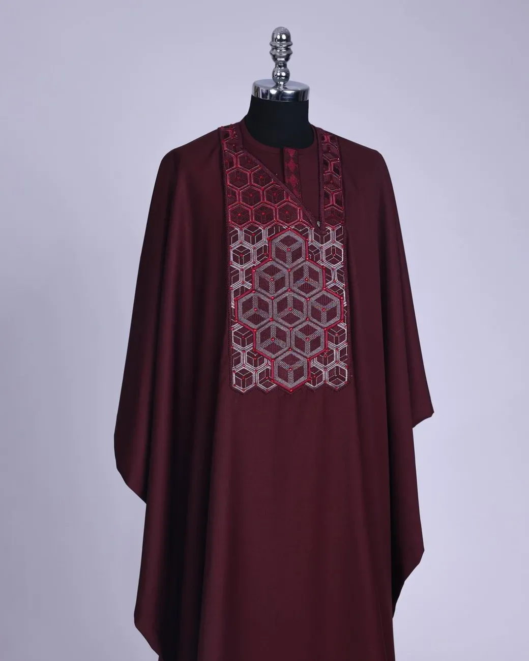 A burgundy, Connected inverted cube -layered 3D embroidery design with splashed burgundy ss30 Swarovski stone details Agbada
