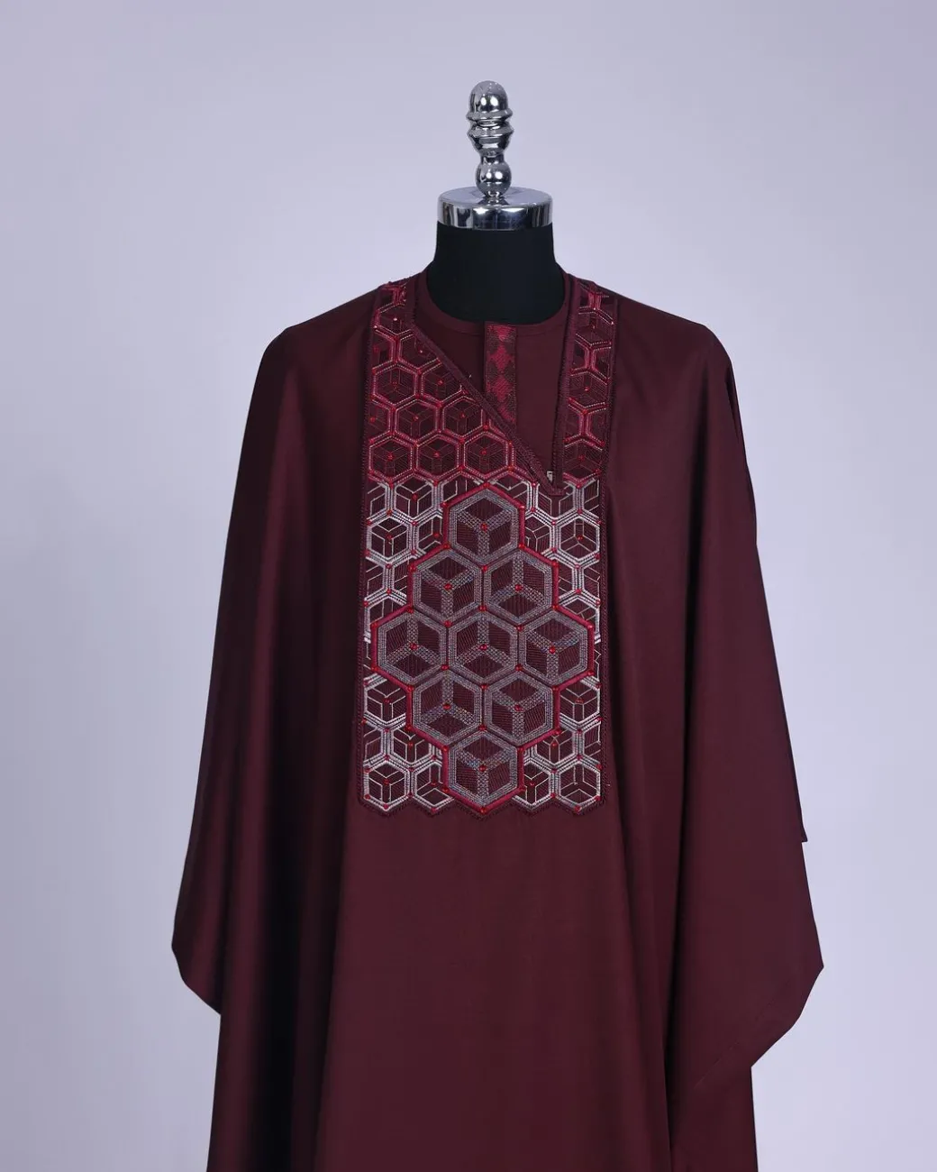 A burgundy, Connected inverted cube -layered 3D embroidery design with splashed burgundy ss30 Swarovski stone details Agbada