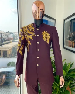 A burgundy safari suit with gold floral pattern embroidery detailing