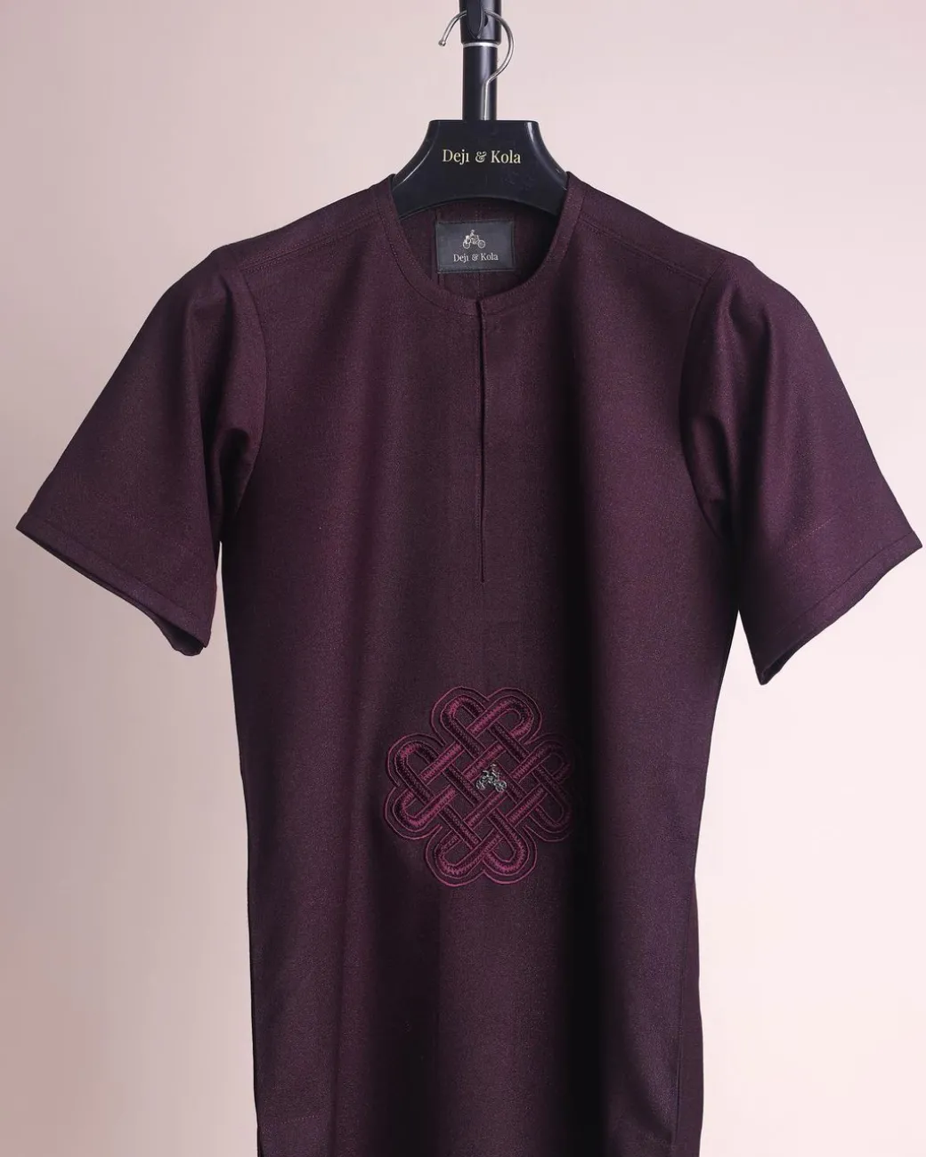 A burgundy, zipline with lower embroidery details, short sleeve African senator kaftan native.