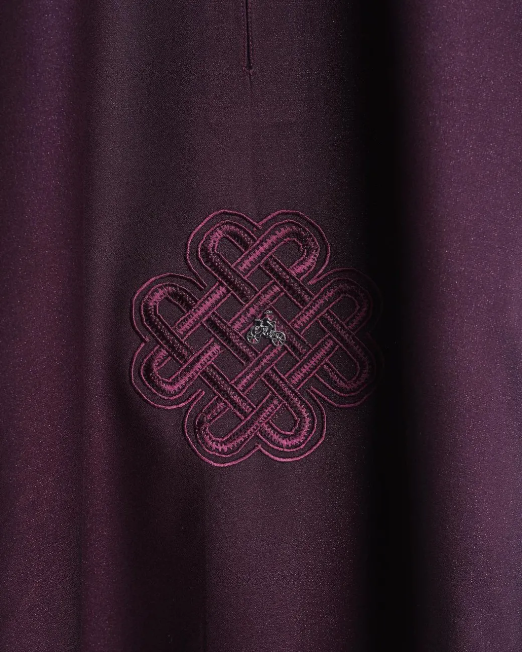 A burgundy, zipline with lower embroidery details, short sleeve African senator kaftan native.