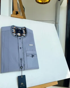 A cadet grey patch pocket and a front flap with a clear view of Swarovski button detail traditional Senator Kaftan native