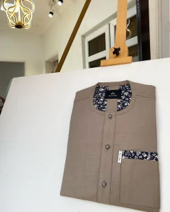 A Carton brown African kaftan with paisley details, Swarovski buttons and sokoto