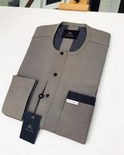 A Carton-colored kaftan with a clear view of black Swarovski button detailing and sokoto