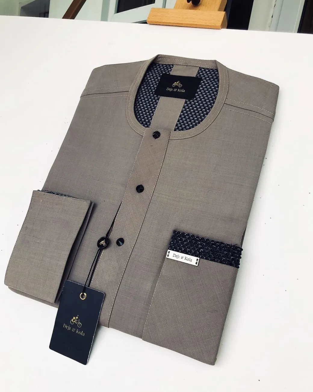 A Carton-colored kaftan with a clear view of black Swarovski button detailing and sokoto