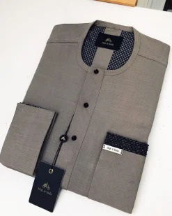 A Carton-colored kaftan with a clear view of black Swarovski button detailing and sokoto