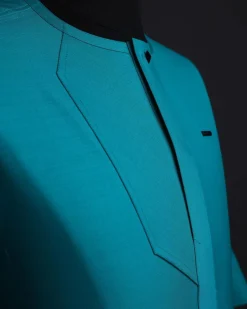 A Castleton green, front flap, patterned flap with black Swarovski button, short sleeve African senator kaftan native.