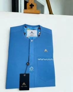 A cerulean blue, vertical Flap with Swarovski button on flap, related embroidery detailing African traditional senator kaftan native.