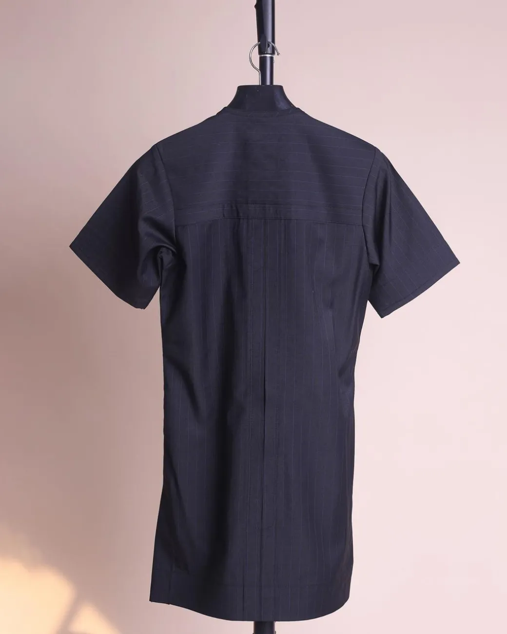 A charcoal black and admiral blue pencil stripe, invisible neckline zip line with layered front flap details, short sleeve African senator kaftan native.