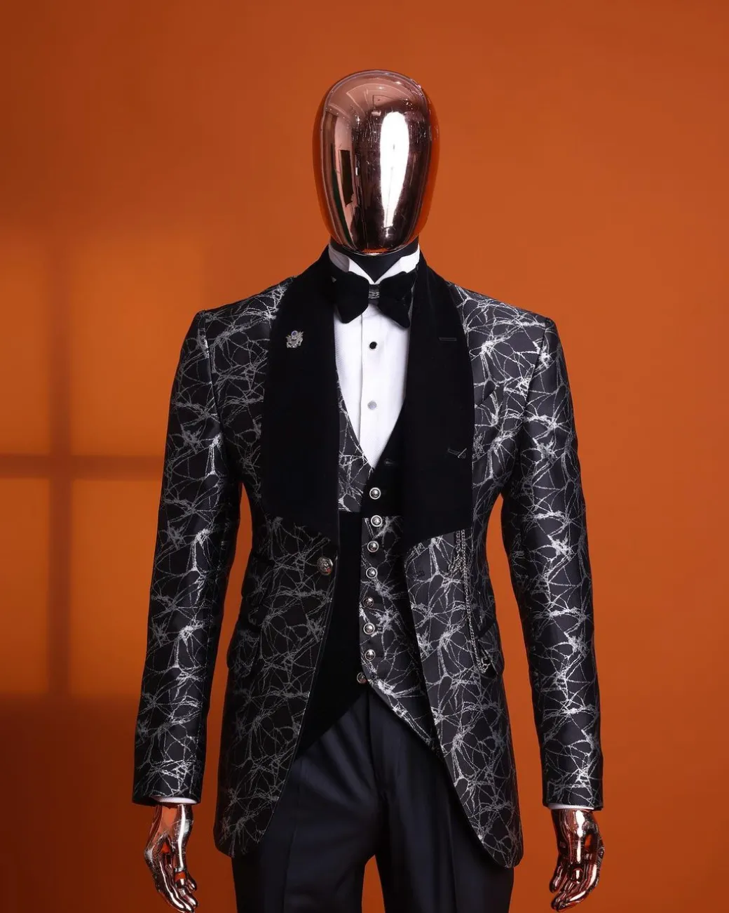 A charcoal black and silver spiral jacquard, shawl lapel tuxedo suit