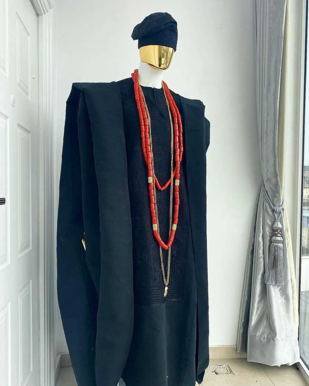 A charcoal black aso oke agbada with box patter embroidery design