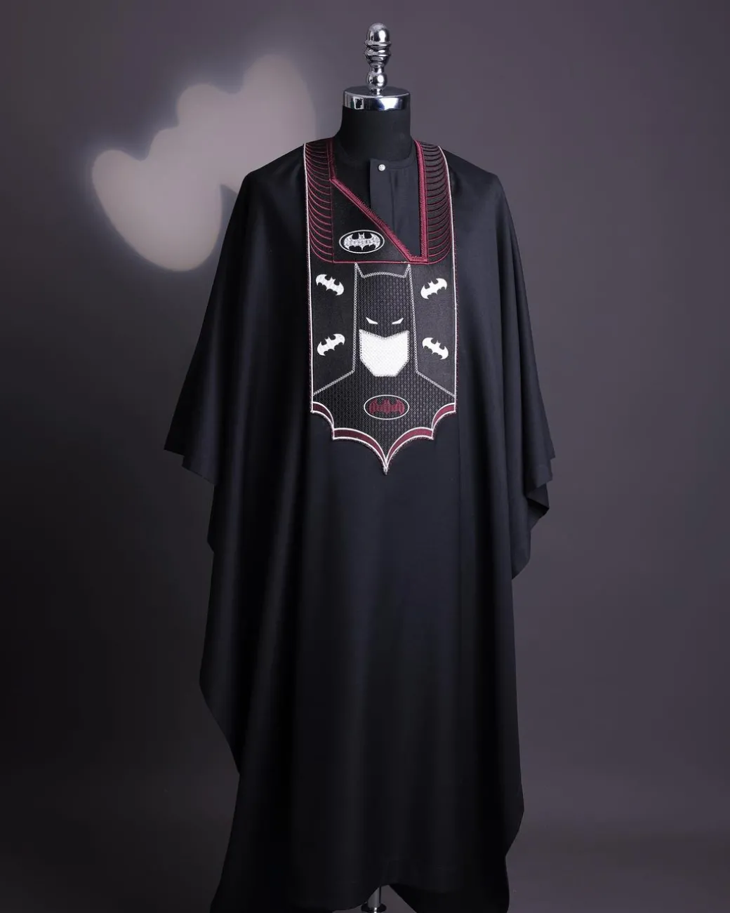 A charcoal black, “Batman VS Gotham” embroidery details agbada