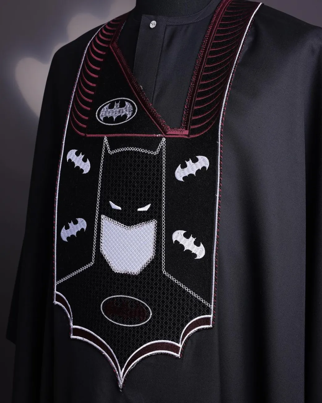 A charcoal black, “Batman VS Gotham” embroidery details agbada