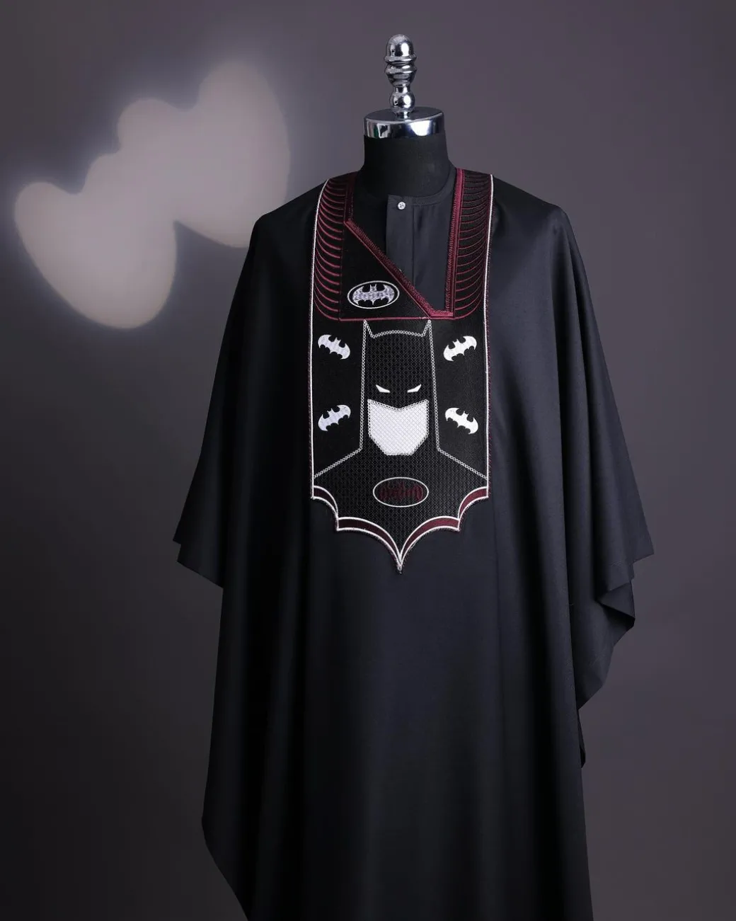 A charcoal black, “Batman VS Gotham” embroidery details agbada
