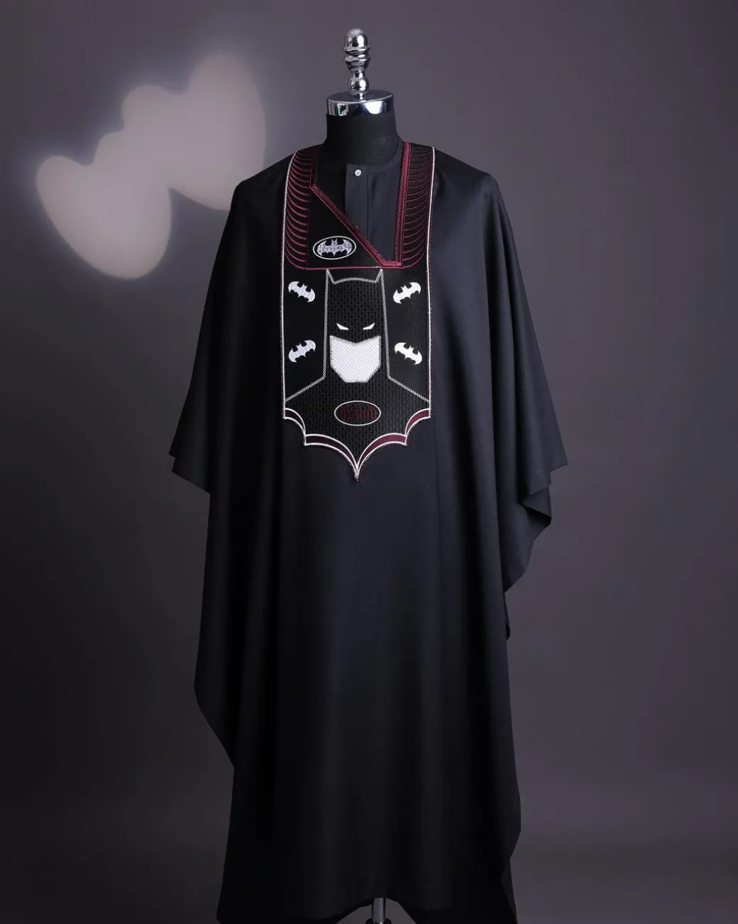 A charcoal black, “Batman VS Gotham” embroidery details agbada