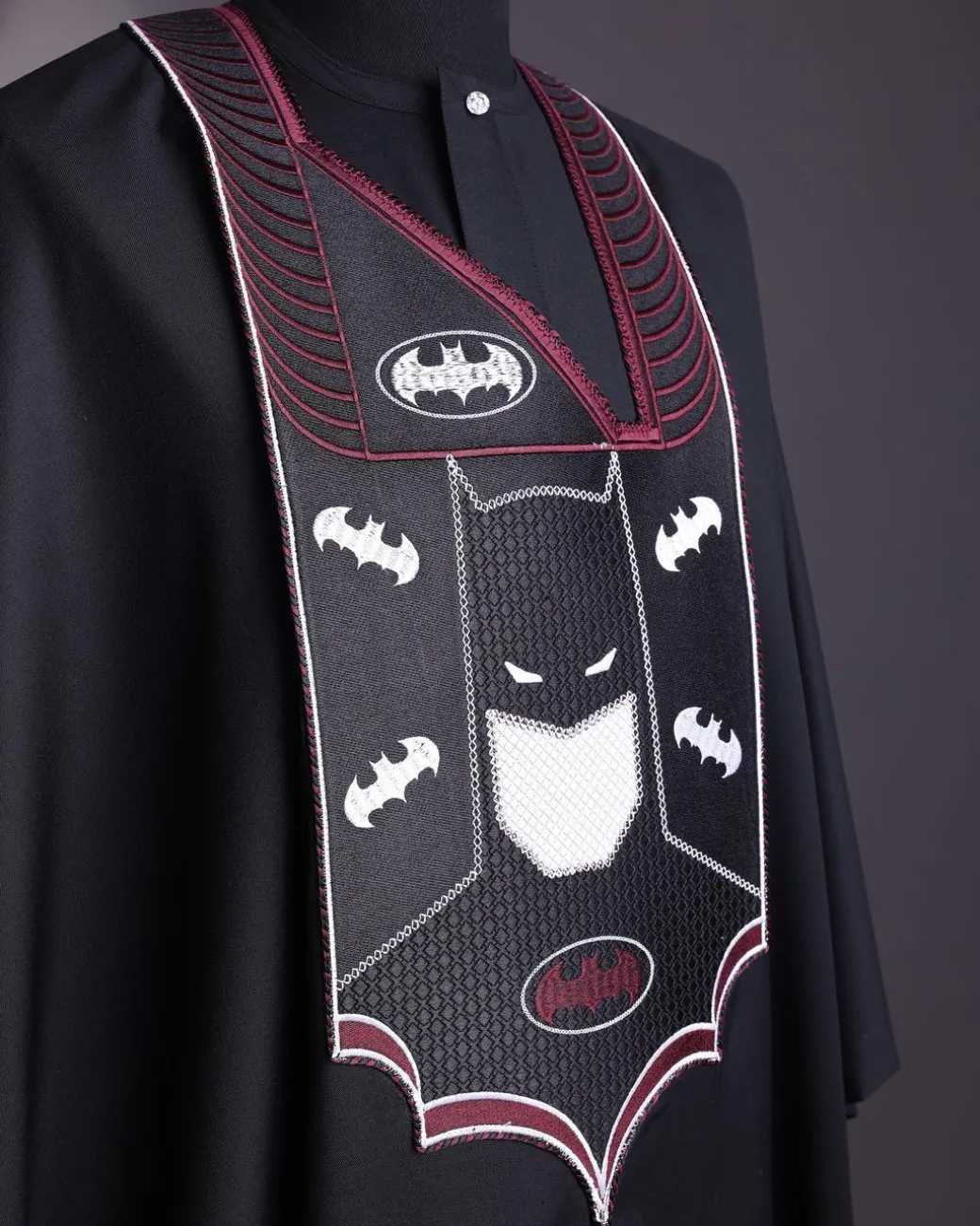 A charcoal black, “Batman VS Gotham” embroidery details agbada