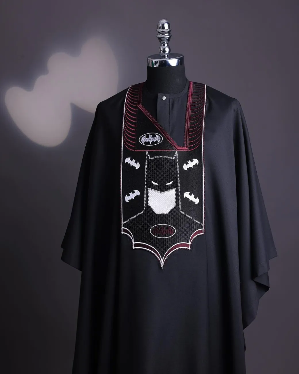 A charcoal black, “Batman VS Gotham” embroidery details agbada