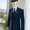 A charcoal black Bespoke reloaded “peaky blinders” peak lapel suit.