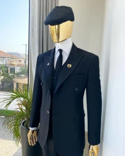 A charcoal black Bespoke reloaded “peaky blinders” peak lapel suit.