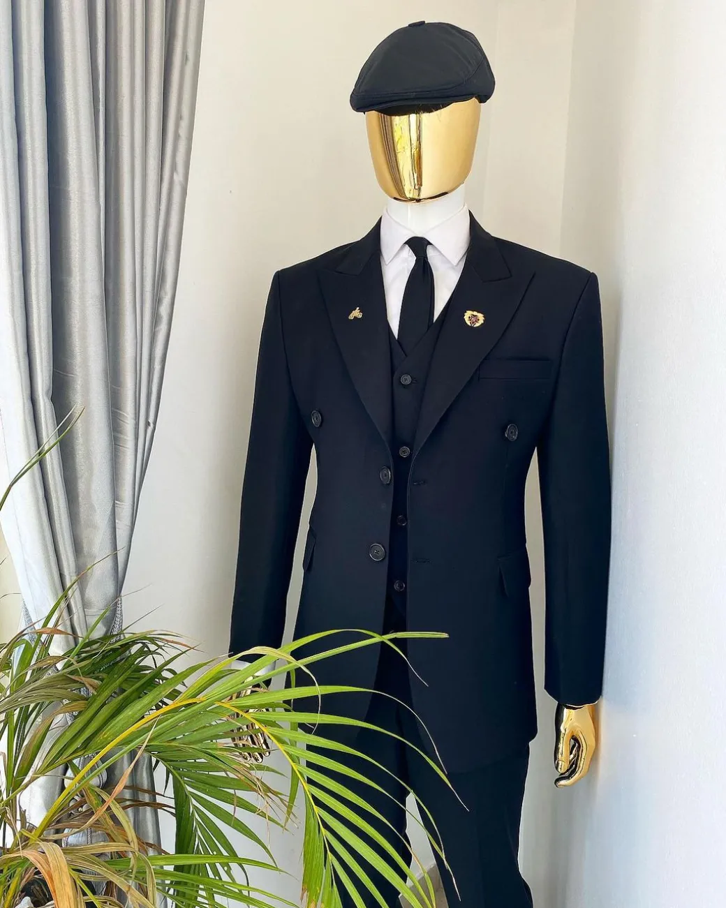 A charcoal black Bespoke reloaded “peaky blinders” peak lapel suit.