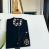 A charcoal black, clear view black Swarovski buttons, hand embroidery patch details, African traditional senator kaftan native