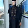 A charcoal black, connected square embroidery design with matching gold and red Swarovski stone details agbada