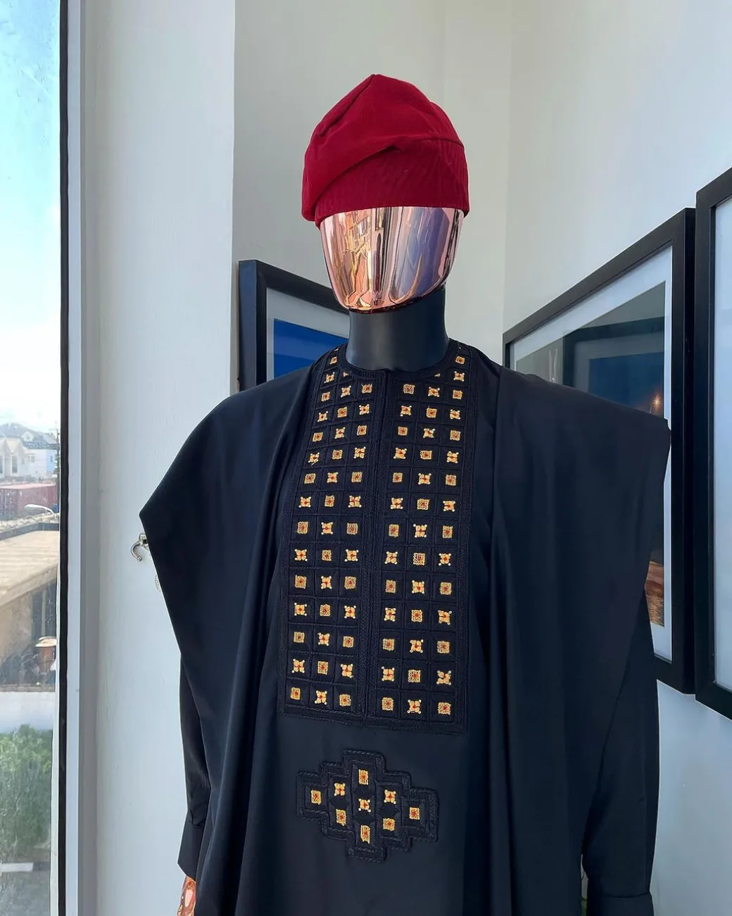 A charcoal black, connected square embroidery design with matching gold and red Swarovski stone details agbada