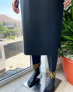 A charcoal black dagbtan, connected star gold embroidery detailing senator native.