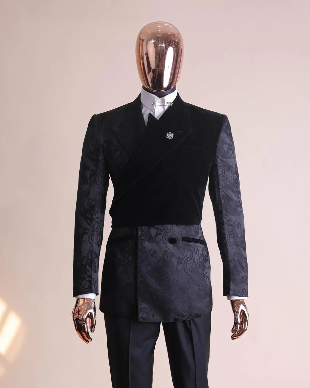 A charcoal black “equalizer” quadruple breasted, knitted, layered peak lapel with velvet overlay-ed tuxedo jacquard suit