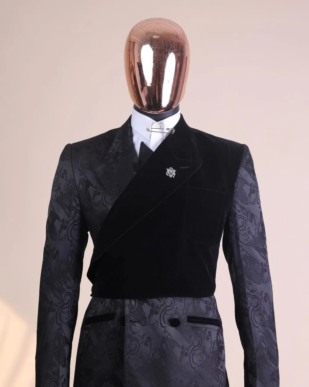 A charcoal black “equalizer” quadruple breasted, knitted, layered peak lapel with velvet overlay-ed tuxedo jacquard suit