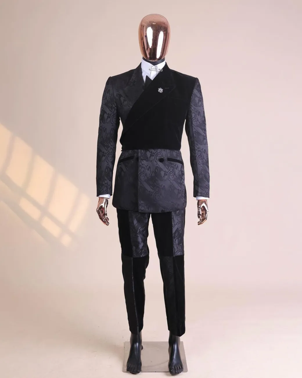 A charcoal black “equalizer” quadruple breasted, knitted, peak lapel with velvet tuxedo jacquard suit