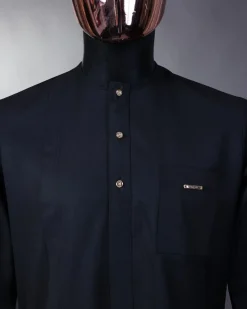A charcoal black front flap with gold Swarovski buttons, patch pocket, and 3/4 sleeve details African senator kaftan native